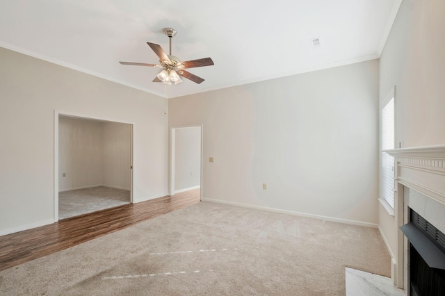 unfurnished living room featuring hardwood / wood-style floors, ceiling fan, and crown molding