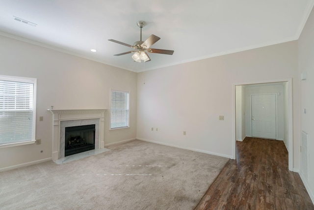 unfurnished living room featuring ceiling fan, dark hardwood / wood-style flooring, and ornamental molding