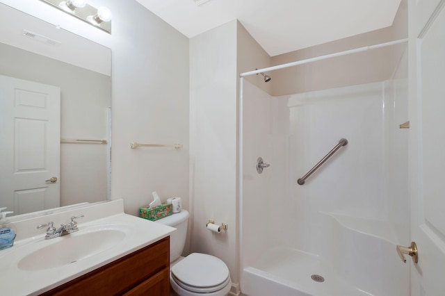 bathroom with walk in shower, vanity, and toilet