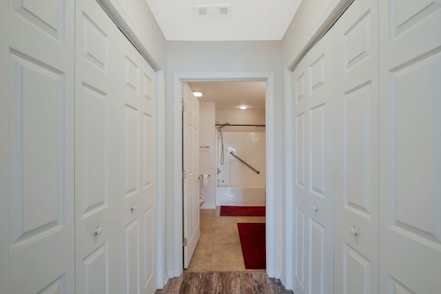 corridor featuring dark hardwood / wood-style floors