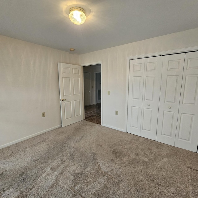 unfurnished bedroom with carpet and a closet