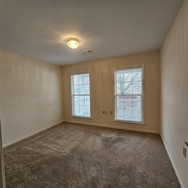 carpeted empty room with plenty of natural light