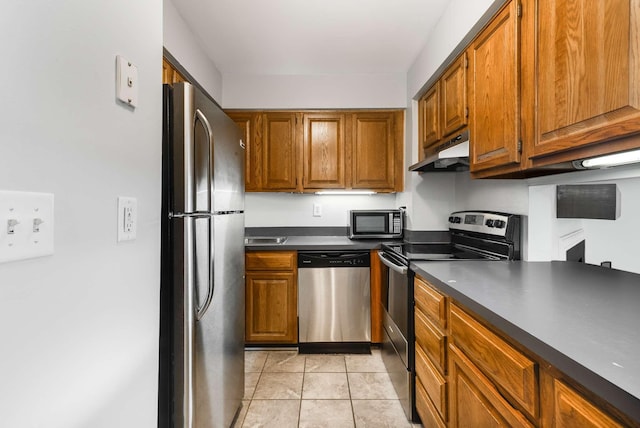 kitchen with appliances with stainless steel finishes and light tile patterned floors