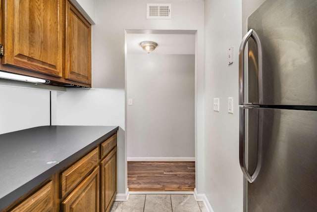 kitchen featuring stainless steel refrigerator