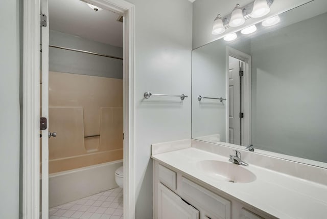 full bathroom featuring washtub / shower combination, tile patterned floors, toilet, and vanity