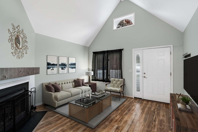 living room featuring dark hardwood / wood-style flooring and high vaulted ceiling