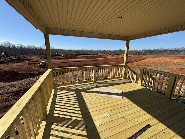 wooden deck with a rural view