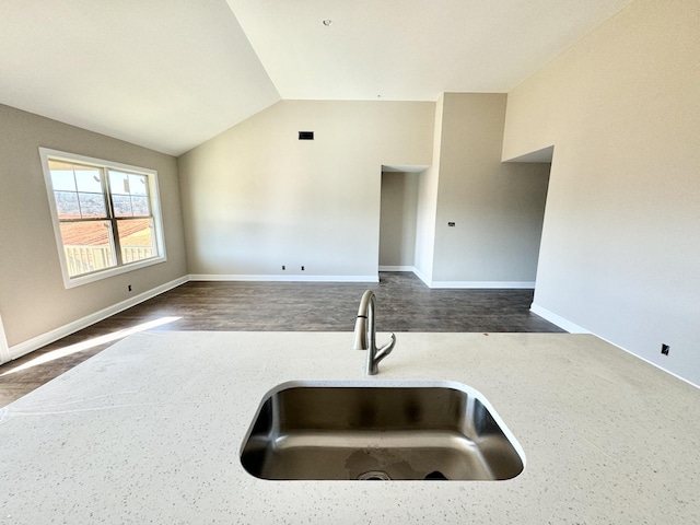 kitchen with lofted ceiling and sink