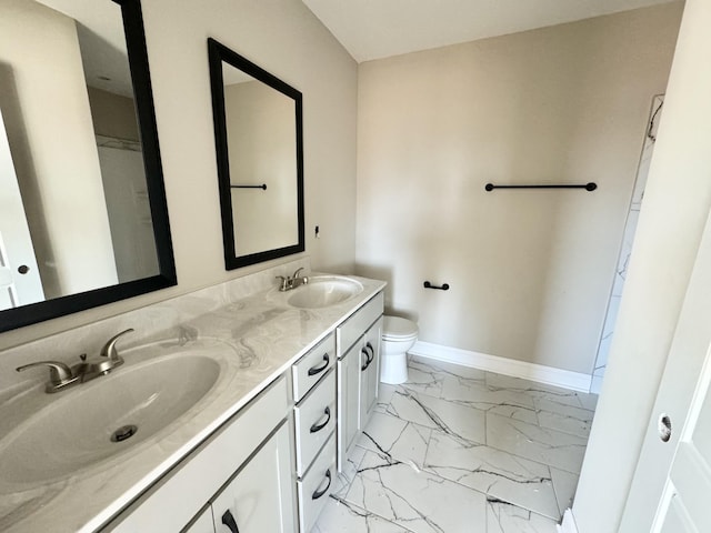 bathroom featuring vanity and toilet