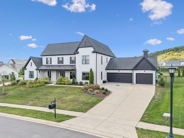 modern inspired farmhouse with covered porch, a front yard, and a garage