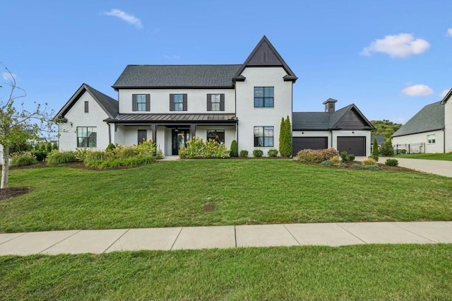 modern farmhouse style home featuring a porch, a garage, and a front lawn