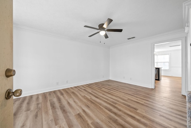 unfurnished room featuring ceiling fan, light wood-type flooring, and ornamental molding