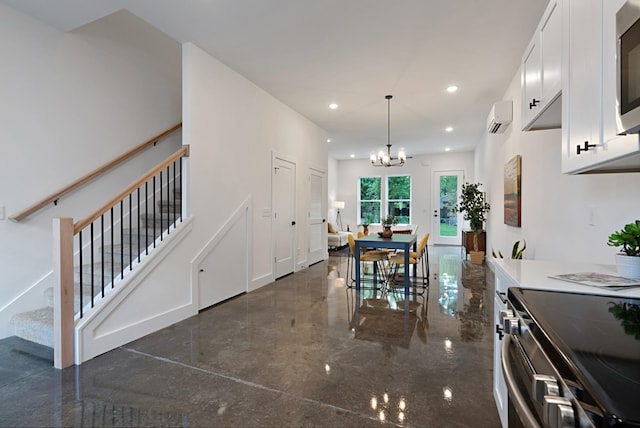 dining area featuring an inviting chandelier and a wall unit AC