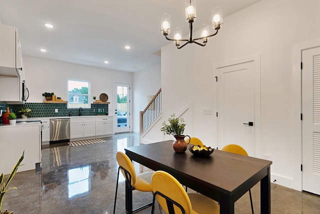 dining area featuring a notable chandelier and sink