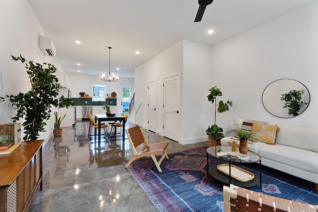 living room with ceiling fan with notable chandelier and an AC wall unit