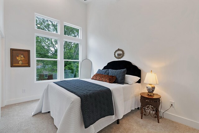 bedroom featuring light colored carpet