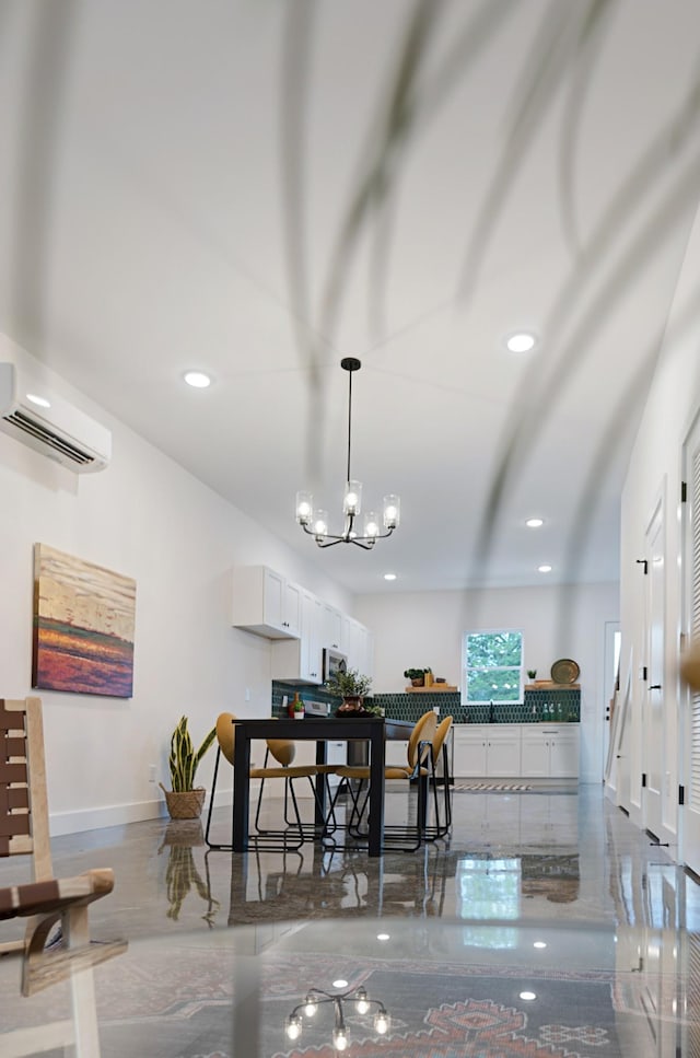 dining space featuring a chandelier and a wall mounted air conditioner