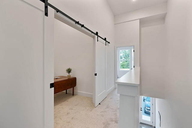 hallway featuring light colored carpet