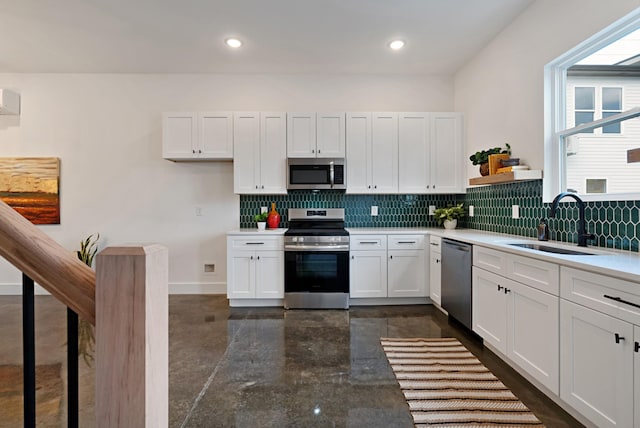 kitchen featuring white cabinetry, sink, appliances with stainless steel finishes, and tasteful backsplash