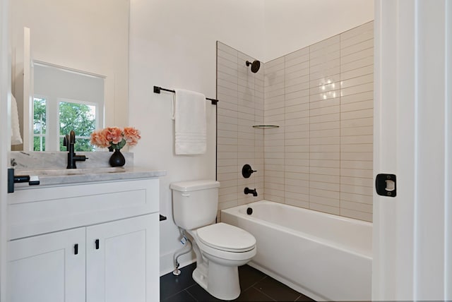 full bathroom with tile patterned floors, vanity, tiled shower / bath combo, and toilet