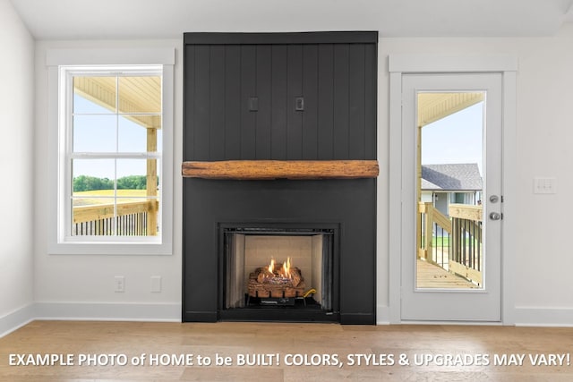 room details featuring wood-type flooring and a large fireplace