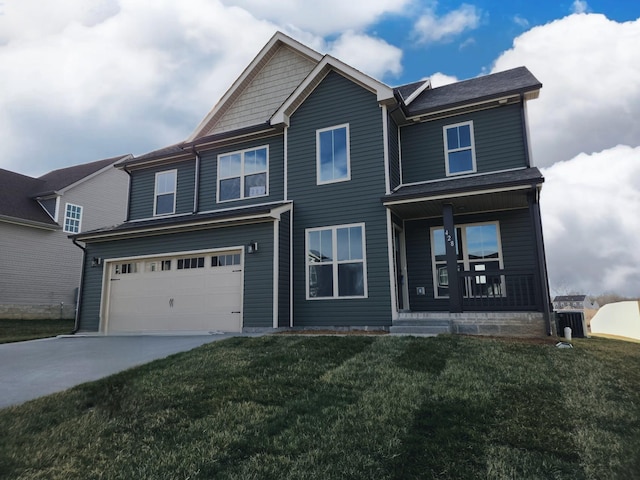 view of front facade featuring a porch, a garage, and a front lawn