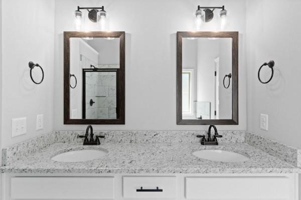 bathroom featuring vanity and a shower with shower door