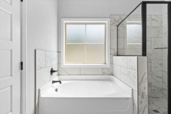 bathroom with separate shower and tub