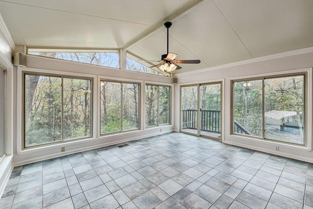 unfurnished sunroom featuring ceiling fan and a wealth of natural light