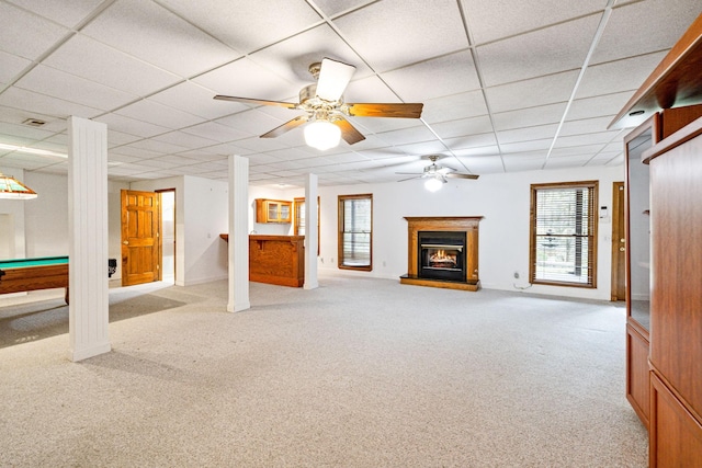 unfurnished living room featuring a paneled ceiling, light colored carpet, ceiling fan, and pool table