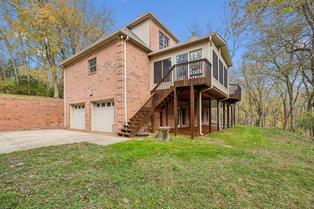 view of front of home featuring a wooden deck, a front lawn, and a garage