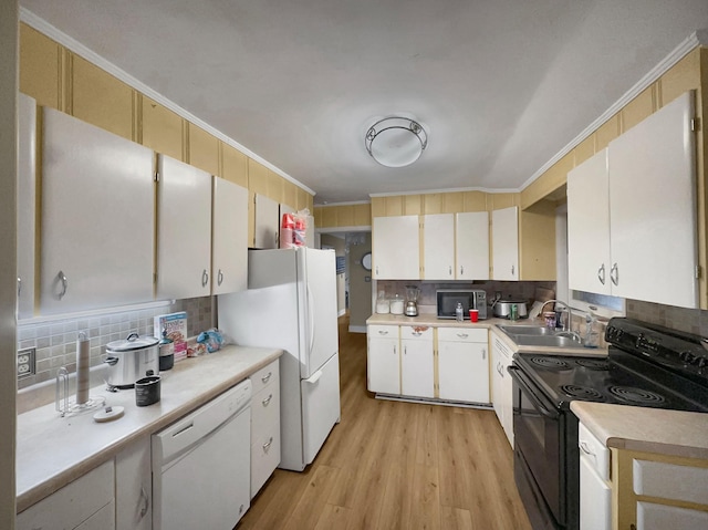 kitchen featuring white cabinetry, sink, light hardwood / wood-style floors, and white appliances