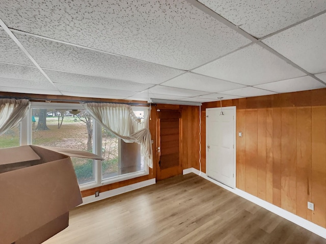 additional living space featuring wood walls and hardwood / wood-style flooring