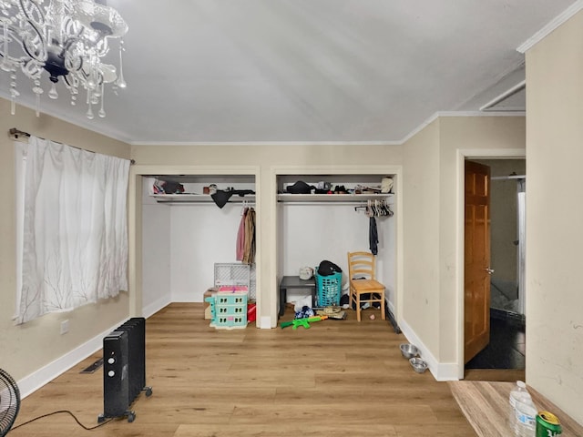 interior space with hardwood / wood-style flooring and ornamental molding