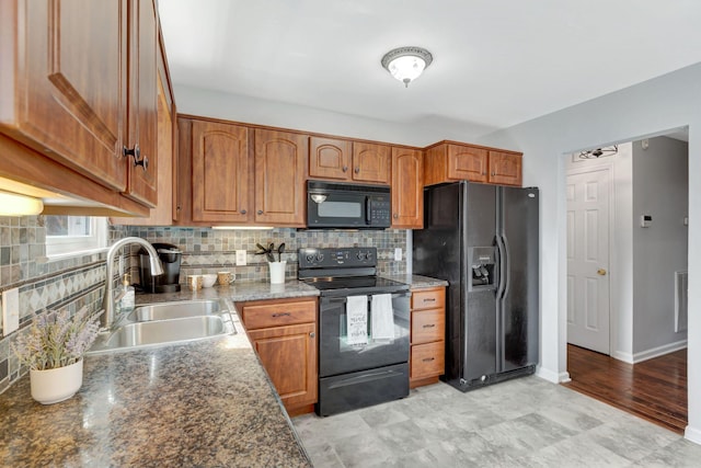 kitchen with black appliances, decorative backsplash, sink, and stone counters