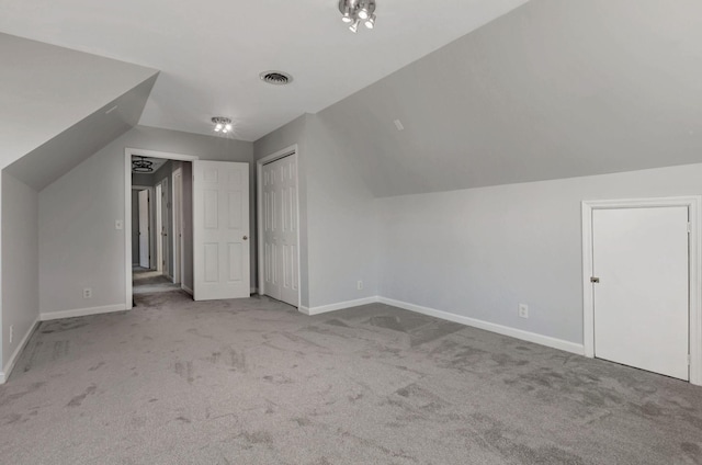 bonus room featuring light colored carpet and lofted ceiling