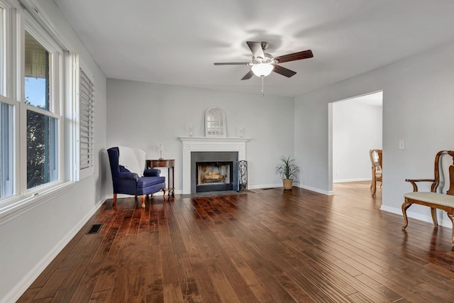 sitting room featuring ceiling fan and dark wood-type flooring