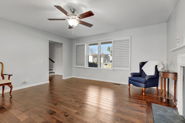 sitting room with dark hardwood / wood-style flooring and ceiling fan