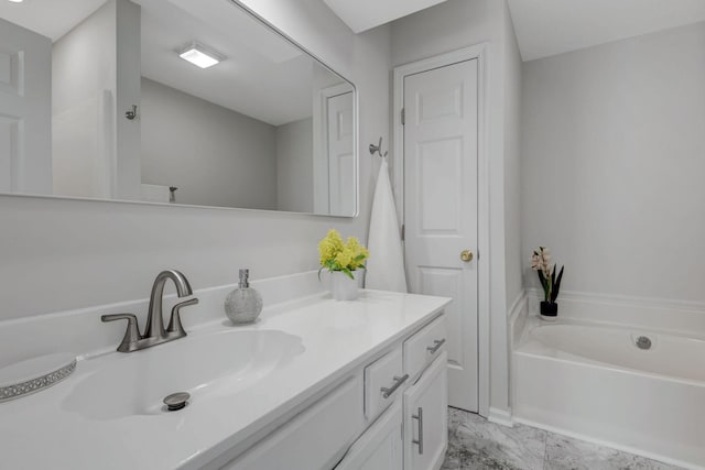 bathroom with a tub to relax in and vanity