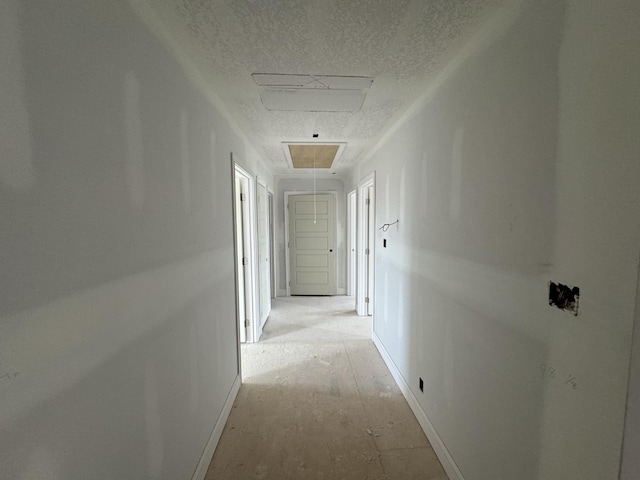 corridor featuring a textured ceiling