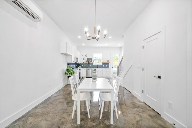 dining room featuring a chandelier, concrete floors, and an AC wall unit