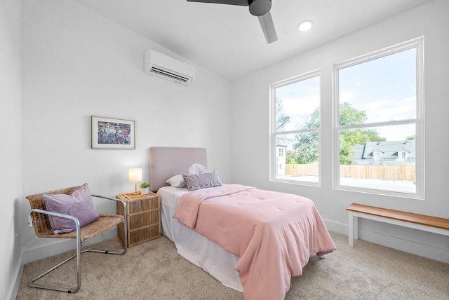 bedroom featuring a wall mounted air conditioner, ceiling fan, light carpet, and multiple windows