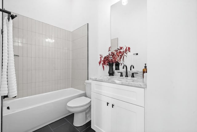 full bathroom featuring tile patterned floors, vanity, toilet, and tiled shower / bath