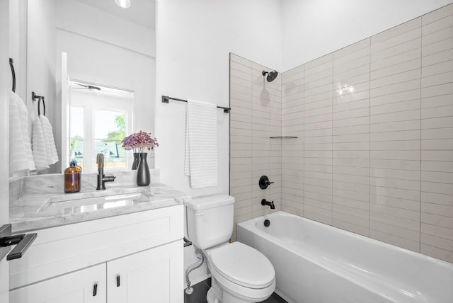 full bathroom with vanity, toilet, and tiled shower / bath combo