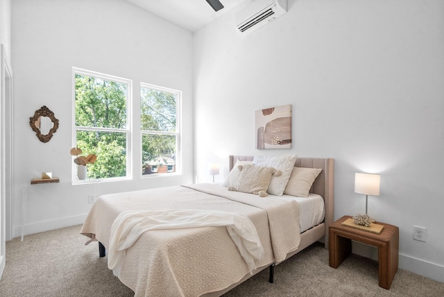 carpeted bedroom with an AC wall unit and ceiling fan