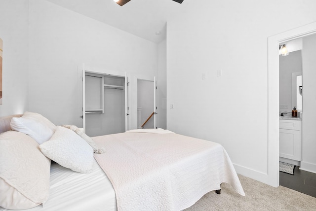 carpeted bedroom with ceiling fan and a closet