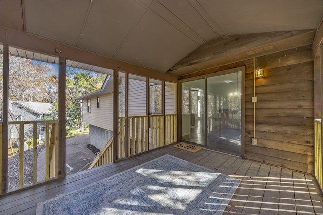 unfurnished sunroom with a wealth of natural light and lofted ceiling