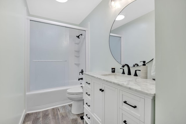 full bathroom with hardwood / wood-style floors, vanity, toilet, and shower / bath combination