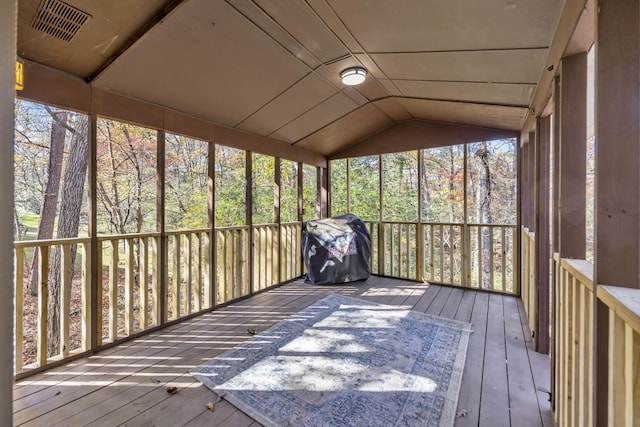 unfurnished sunroom featuring vaulted ceiling