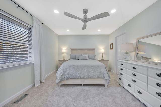 bedroom with ceiling fan and light carpet